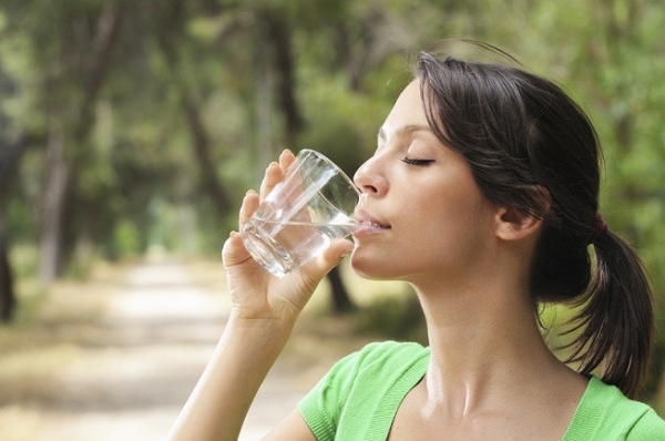 young woman drinking with waterglass